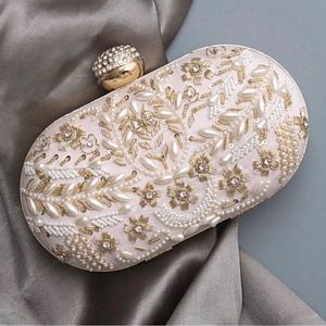 White oval shaped pearl clutch